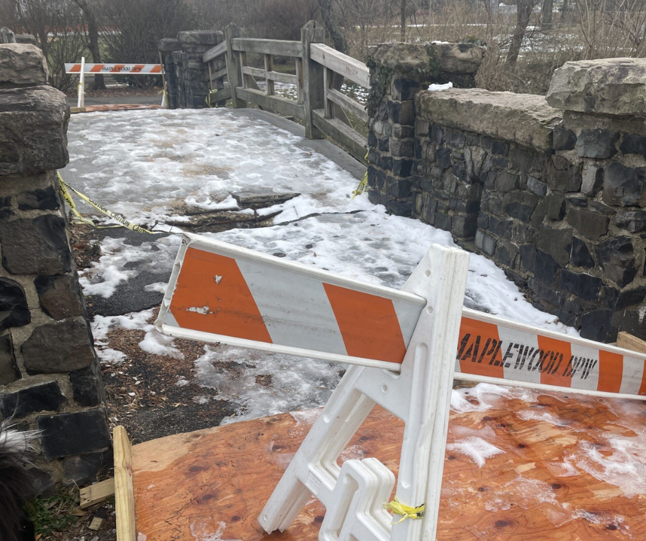 Image of the Maplewood Duck Pond Bridge, closed with a DPW construction barricade blocking it off. There is snow on the ground.