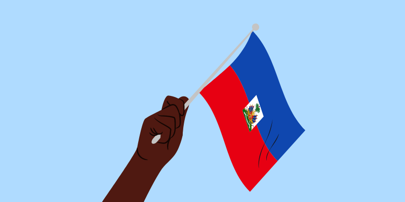 Image of a Black hand waving a Haitian flag. The background is sky blue.